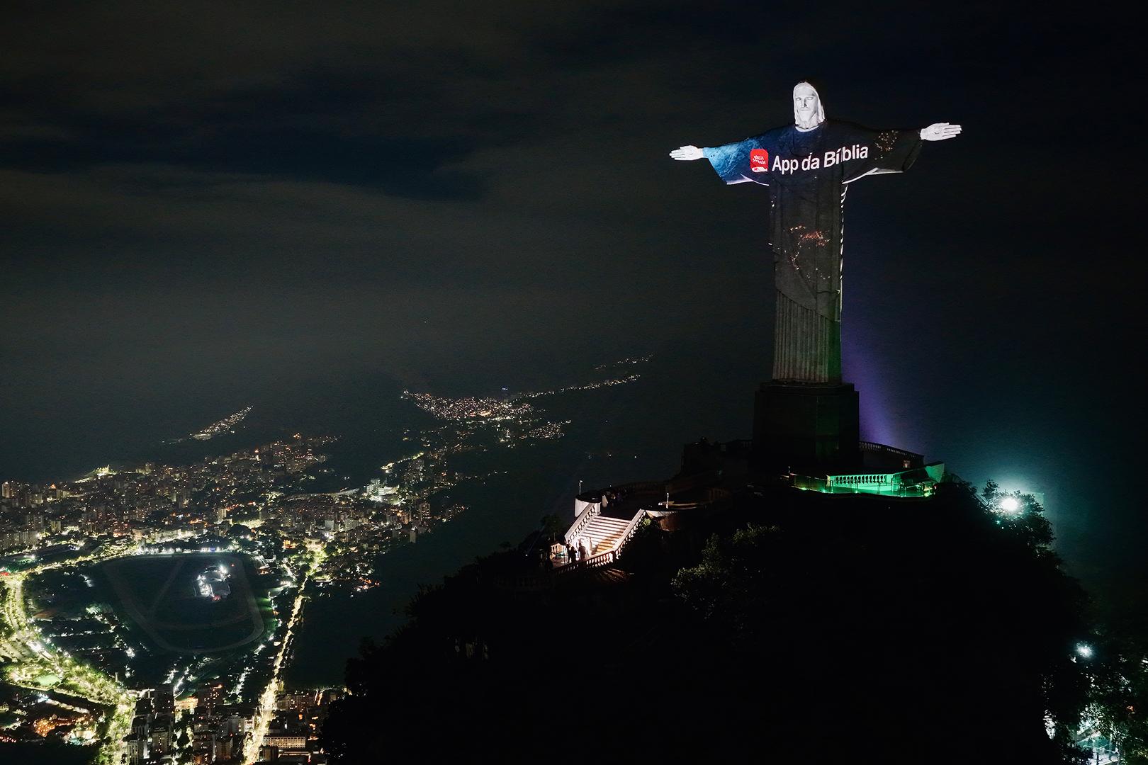 YouVersion ad illuminates the Christ the Redeemer statue with the Rio skyline in the background.