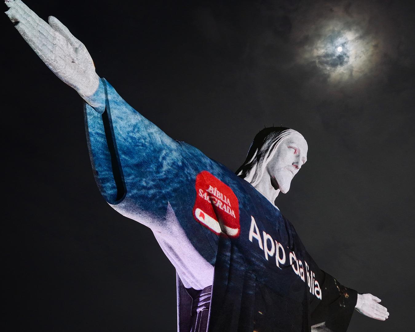 YouVersion ad illuminates the Christ the Redeemer statue with the Rio skyline in the background.